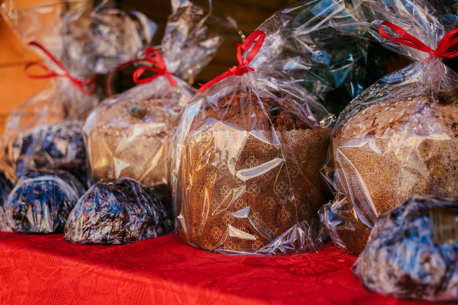 a table topped with bags of cookies and muffins