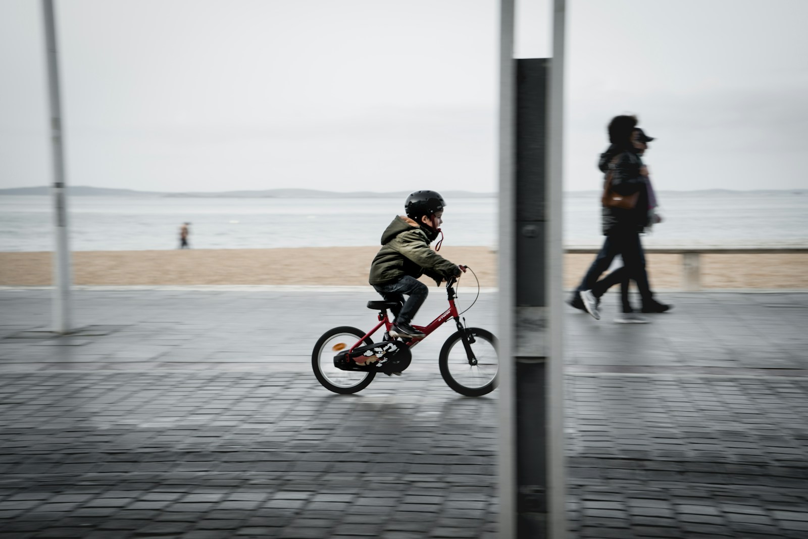 man in black jacket riding on red bicycle during daytime